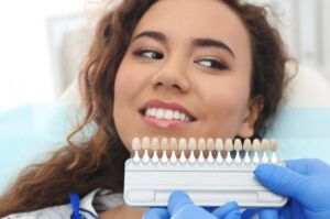 Dentist matching patient's teeth