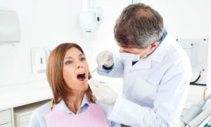 Woman undergoing treatment at her dentist - Park Meadows Dental